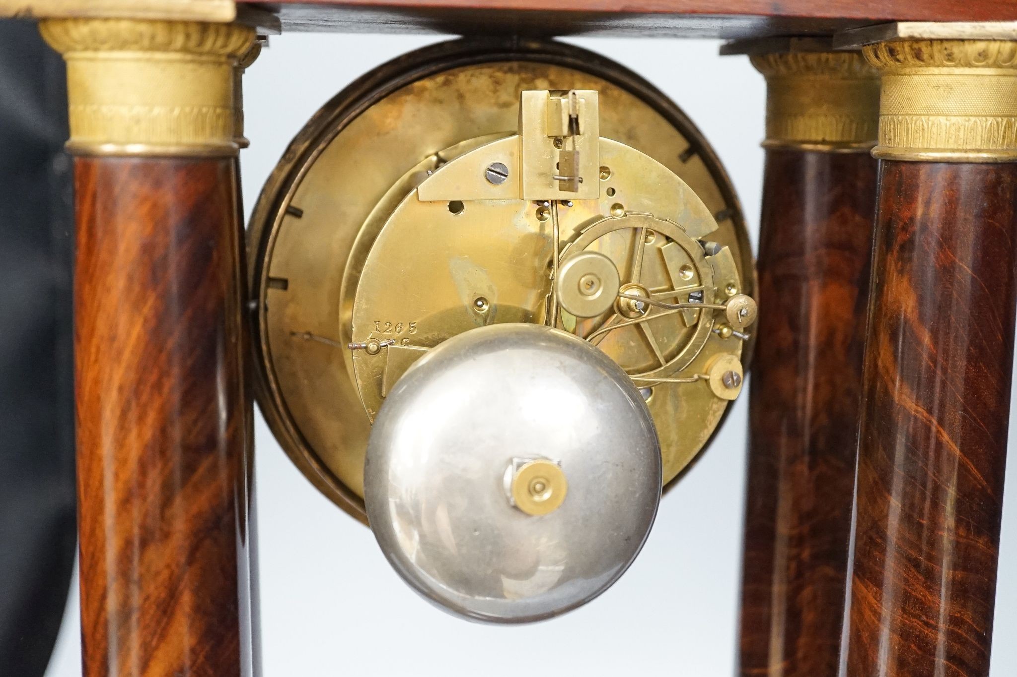 An early 19th century mahogany portico clock with three keys and spare bell, 50cm